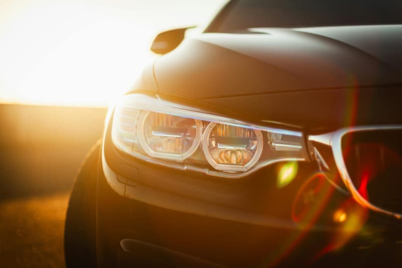 Sunlit close-up of a modern car headlight